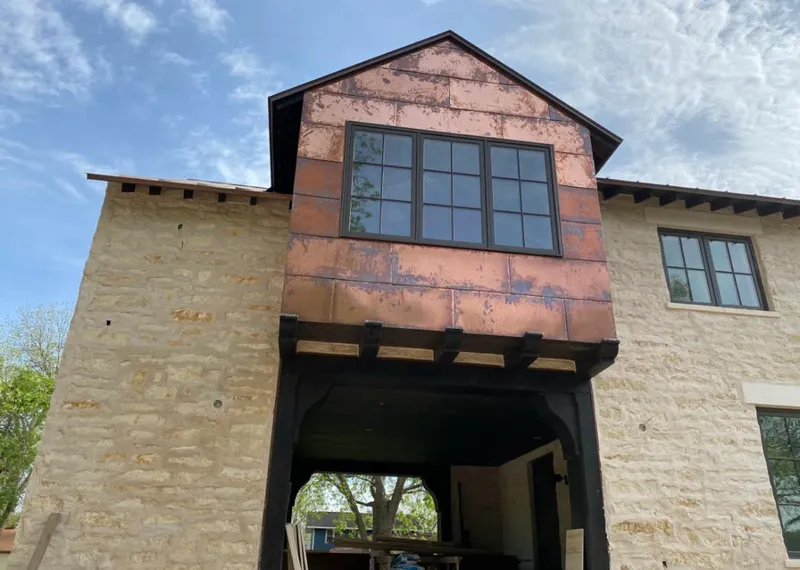 Copper metal panel facade on a stone building for Roof Repair in Eaton Rapids
